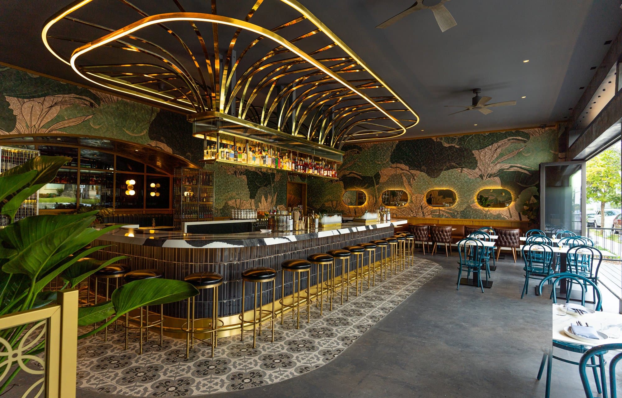 Circular marble bar under a brass metal canopy at Kingfisher in Golden Hill