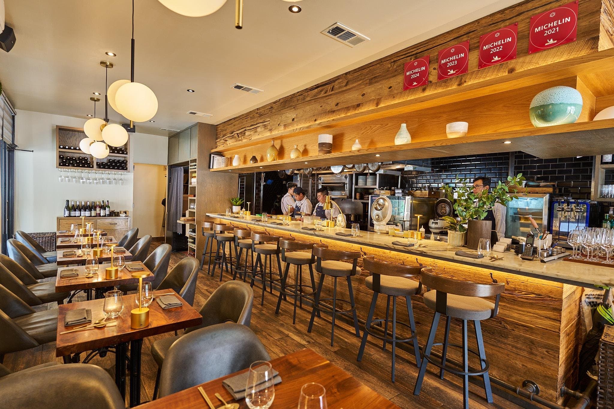 Kochi Hell’s Kitchen dining room and open kitchen with Michelin plaques