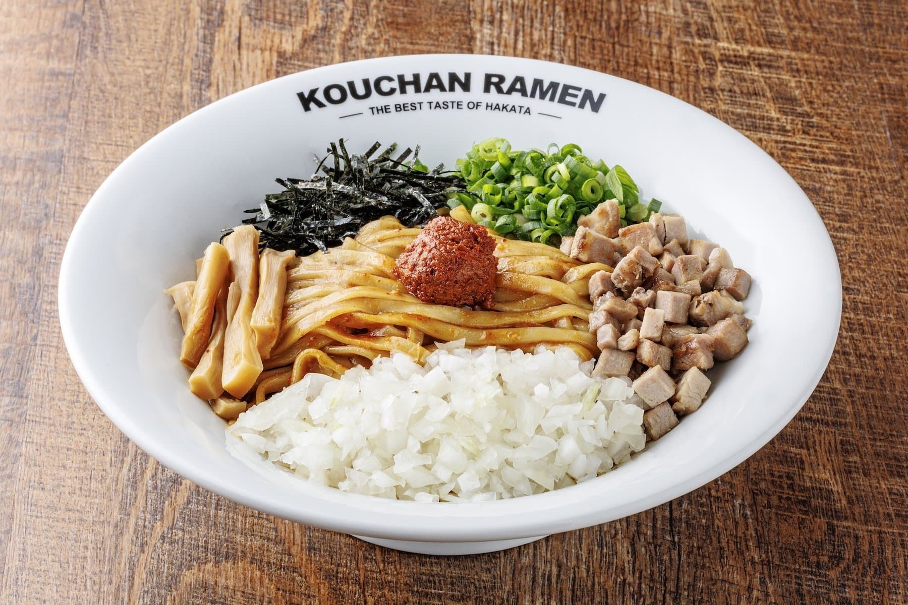 Overhead of a Kouchan spicy mazemen bowl with chashu, nori, and green onion