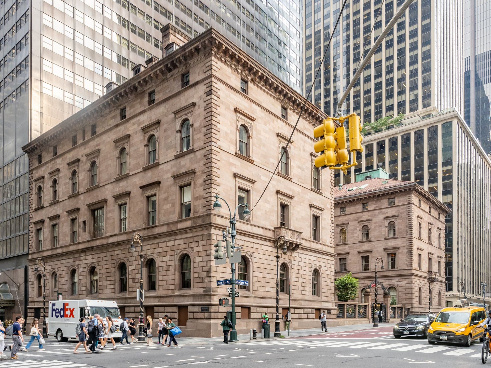 The stone Villard Houses at Madison Avenue and 50th Street, with the Lotte New York Palace tower behind them