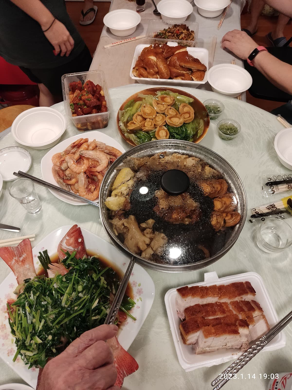 Family-style Chinese reunion dinner on a round table with lazy Susan