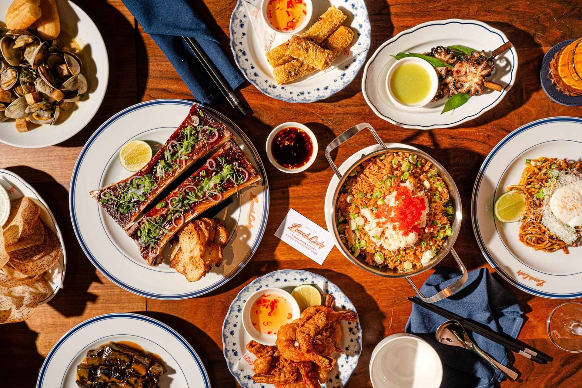 Overhead of a Lunch Lady Toronto table with short rib, crab fried rice, and prawns