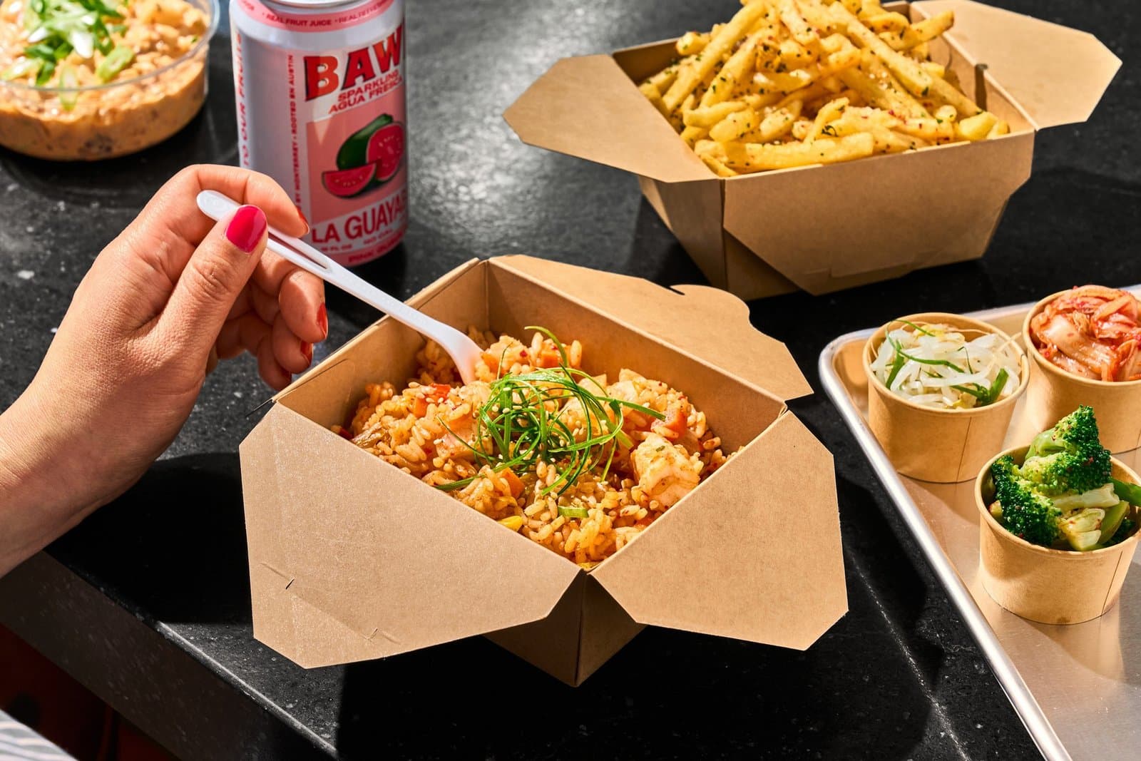 Takeout kimchi fried rice with fries and three banchan cups at Mess Hall Boda