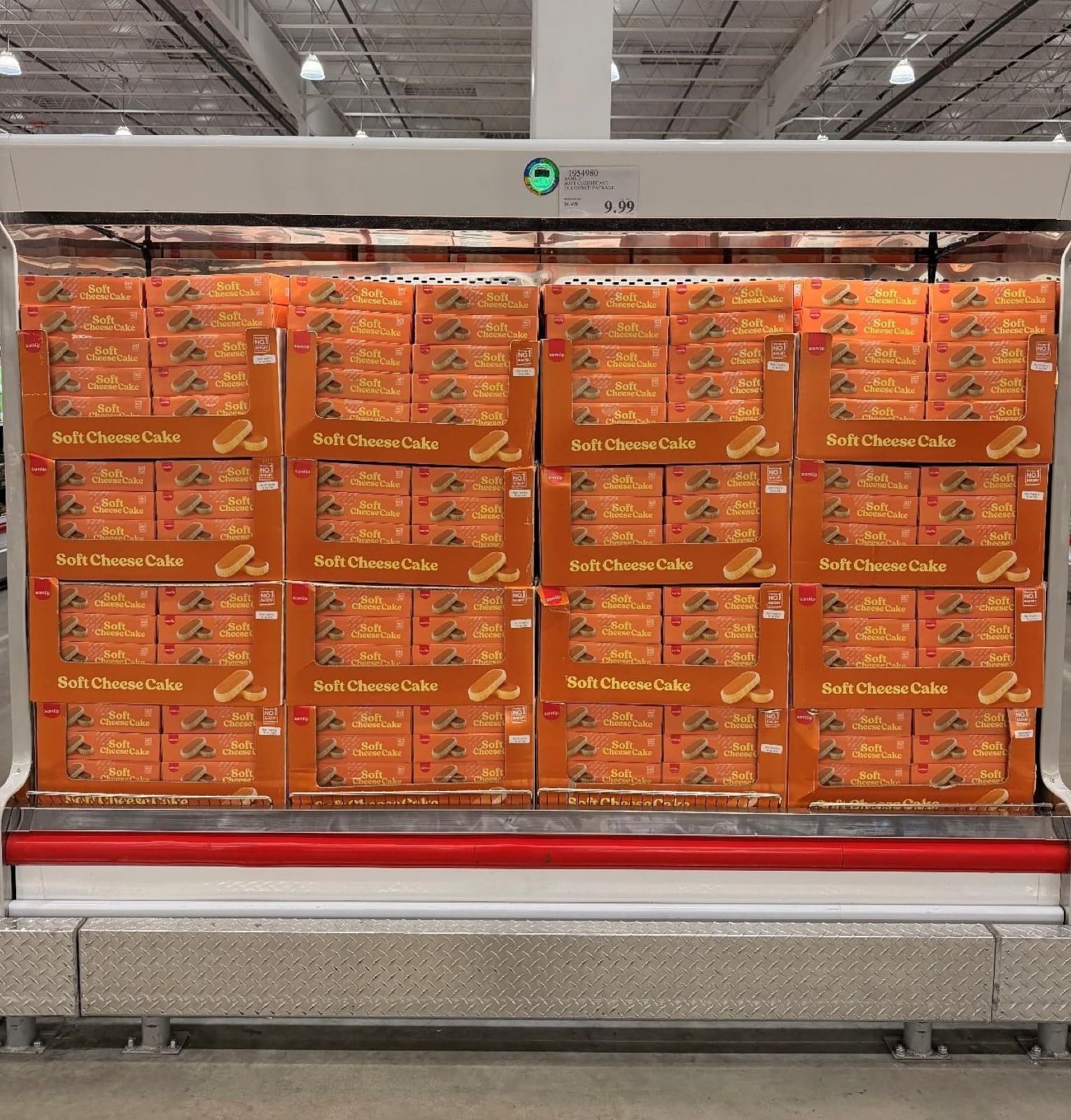 Costco refrigerated case stacked with orange Samlip Soft Cheese Cake cartons